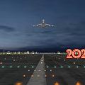 Airplane Flying Over Illuminated Runway Lights With 2021 Sign In Evening Sky