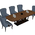 Elegant Oval Wooden Dining Table With Blue Tufted Chairs White Candle Holders And Black Bowl