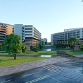 Modern School Buildings On Scenic Campus With Green Trees Lawns Pathways And Water Features
