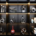 Modern Decorative Ornament Set on Lit Black Shelves with Metallic and Geometric Designs