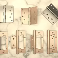 Various Metal Hinges With Different Designs On Marble Surface For Home Hardware 3d model