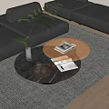 Round Coffee Table with Tray Glasses Books and Green Plant near Gray Sofa on Rug