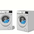 Two Modern White Washing Machines With Digital Display Transparent Door And Blue Clothes Inside