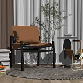 Modern Leisure Chair Featuring Brown Leather Cushion Black Frame And Indoor Plant With Woven Rug