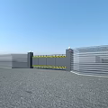 Sturdy Metal Entrance Gate With Yellow Warning Stripes Pillars And Fencing On Gravel Ground