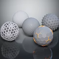 Different Textured Spheres With Holes Bumps Hexagonal Patterns And Orange Accents On Gray Background