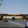 Modern Yellow Frame Entrance Gate With LOGO Vehicles And Landscaped Surroundings