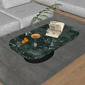 Oval Marble Top Coffee Table With Green Plant Gold Tray Oranges And Books On Rug