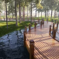 Scenic Wooden Boardwalk Pathway In Park With Trees Grass And Water