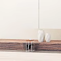 Modern Side Table With Wooden Top And Metal Frame Featuring White Cup And Decorative Vases