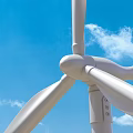 Wind Turbine Blades And Hub Structure Against Blue Sky With Clouds