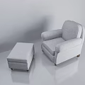 Light Gray Upholstered Armchair with Matching Ottoman and Wooden Legs in Minimalist Neutral Background