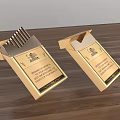 Two Golden Boxes of Daily Life Supplies with Elegant Design on Wooden Surface