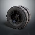 Pair of Off Road Tires with Deep Tread Pattern and Black Rims on Gray Background