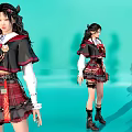 Young Women In Plaid Skirt And Black Red Outfit With Decorative Accessories And Boots