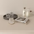 Stylish Clear Glass Cups on Wooden Tray with Decorative Books and Bottles