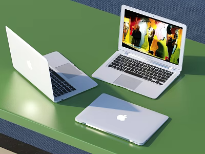 Three Apple Laptops Open And Closed On Green Table With Colorful Screen 3d model