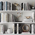 Decorative Ornament Set on Bookshelf with Books Gold Bird Figurine Circular Decor and Stacked Plates