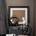 Stylish Over Ear Headphones With Gold Accents On Black Audio Speaker Near White Bust