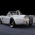 White Convertible Sports Car With Black Racing Stripes And Large Alloy Wheels