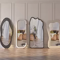 Various Shaped Decorative Mirrors Reflecting Living Room Interior With Wooden Floor And Paneled Walls