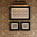 Abstract Paintings Framed in Black Hanging on Patterned Wallpaper with Overhead Lighting