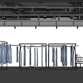 Clothing Store With Metal Racks Blue Jeans White Walls Black Ceiling Lighting And Small Table