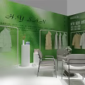 Green Exhibition Booth with Fairy Text Clothing Display and Cacti Plants Decorations
