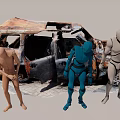 Three Colored Human Figures Standing Near Burned Old Car Outdoor Scene