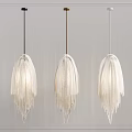 Modern White Fringed Pendant Lights With Black Gold White Cords Against Gray Wall