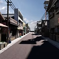 Traditional Commercial Street With Japanese Style Buildings And Shop Signboards