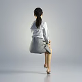 Elegant Woman in White Shirt and Gray Skirt Sitting with High Heels on Gray Background