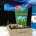 JIANGHO Exhibition Booth Design With Blue White Displays Digital Screens And Green Grass Decor