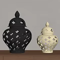 Decorative Black And Cream Vases With Cutout Patterns On Wooden Tabletop Against Light Wall