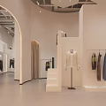 Modern Minimalist Clothing Store Interior With Curved White Walls Clothing Racks And Sofa