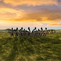 Ancient Battlefield Scene With Soldiers On Horses And Decorative Banners Under Sunset Sky