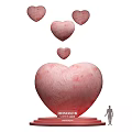 Art Installation Featuring Large Pink Heart Base Unconditional Love Text Floating Small Hearts And Figure