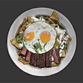 Sliced Steak Fried Eggs Bowl With Tortilla Chips Green Herbs And White Sauce