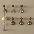 Decorative Hooks on Beige Wall with Brown Wooden Knobs Silver Copper Bases Holding Owl Bell 3d model