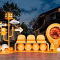 Orange Illuminated Art Installation with Directional Signs Seats and Spheres in Night Building Scene
