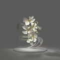 White Flower Sculpture With Green Leaves Curved Stems And White Base On Gray Background