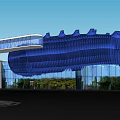 Modern Architectural Building With Blue Wavy Roof Glass Facade And Adjacent White Structure
