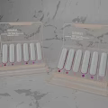 Elegant Decorative Ornament Display Set With White Cylindrical Pieces On Gray Textured Countertop