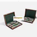 Two Open Wooden Cases With Green Interiors And Colorful Items Inside