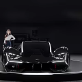 Black Futuristic Sports Car Showcased On Display Platform With Sleek Design And Model
