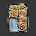 Golden Brown Sweet Rolls In Blue And White Baking Dish With Frosting