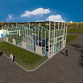 Industrial Factory Building with Glass Facade in Green Outdoor Area Under Blue Sky and Clouds