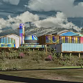 Modern Building Featuring Colorful Glass Facade With Mountain View And Green Plants