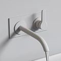 Matte Black Two Handle Wall Mounted Faucet With Water Flowing Over Modern Kitchen Countertop