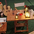 Outdoor Wooden Table and Chair Set With Candle Lanterns Guitar and Clay Pots on Grass